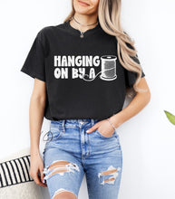 Load image into Gallery viewer, Hanging On By A Thread Graphic Tee