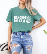 Load image into Gallery viewer, Hanging On By A Thread Graphic Tee